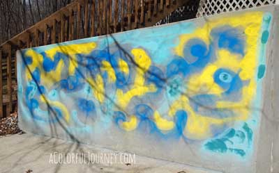 Using chalk spray paints to go crazy with graffiti outside...and it will all wash away by Carolyn Dube