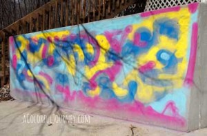 Using chalk spray paints to go crazy with graffiti outside...and it will all wash away by Carolyn Dube