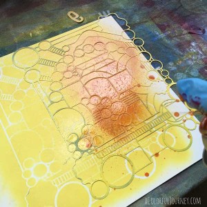 Playing around layering spray paints and a stencil to create patterned papers
