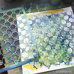 I'm using spray paints with a stencil to create patterned paper