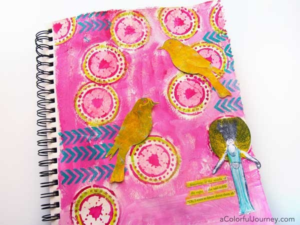 Video by Carolyn Dube showing her play in her art journal from the start including how she found inspiration for the different layers and steps from napkin collaging, stenciling, found poetry, and more!