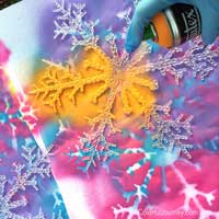 Liquitex spray paint and plastic snowflakes for a bright and rainbow decoration!