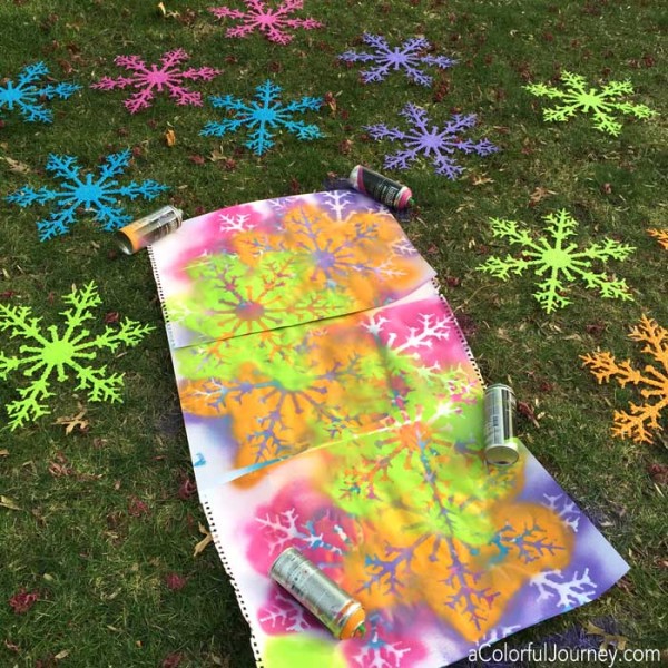 Liquitex spray paint and plastic snowflakes for a bright and rainbow decoration!