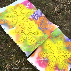 Liquitex spray paint and plastic snowflakes for a bright and rainbow decoration!