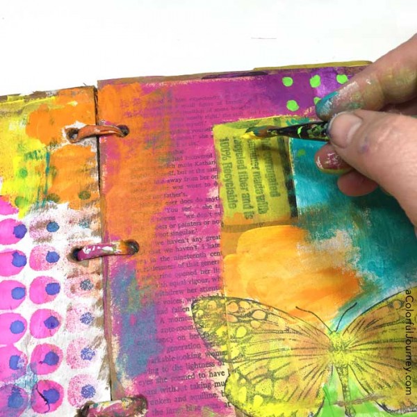 Video tutorial adding layers of color in a cardboard art journal with Carolyn Dube