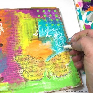 Video tutorial adding layers of color in a cardboard art journal with Carolyn Dube