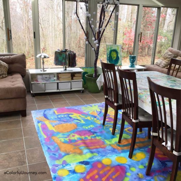 Making a floor cloth with a giant paint brush and spray paints