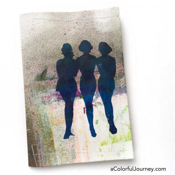 Stenciling the cover of an art journal with silhouettes by Carolyn Dube