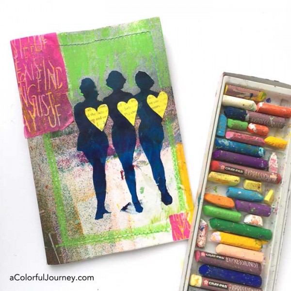 Stenciling the cover of an art journal with silhouettes by Carolyn Dube