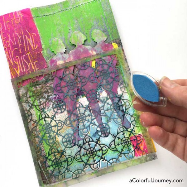 Stenciling the cover of an art journal with silhouettes by Carolyn Dube