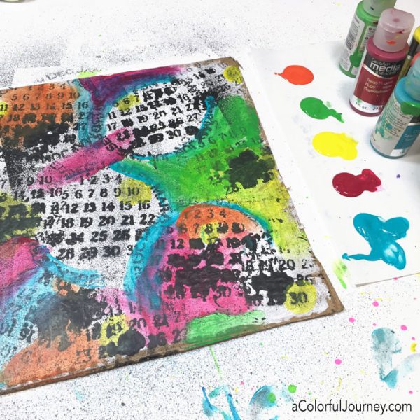 Playing around with a stencil and spray ink on cardboard video tutorial by Carolyn Dube