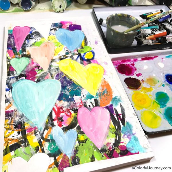 Leftover scraps become stenciled and watercolored mixed media wall art tutorial by Carolyn Dube