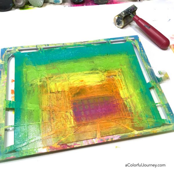 Gel printing with a stencil into an art journal to create a rainbow room tutorial by Carolyn Dube