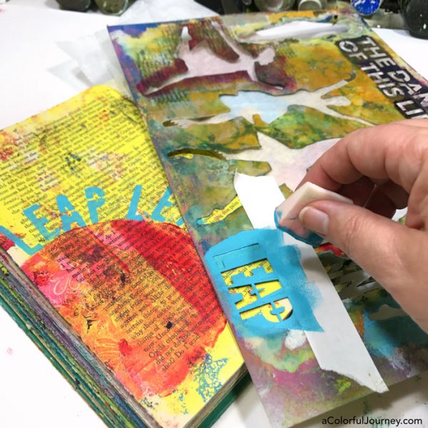 Stenciling with a mask in a gel printed altered book art journal video tutorial by Carolyn Dube