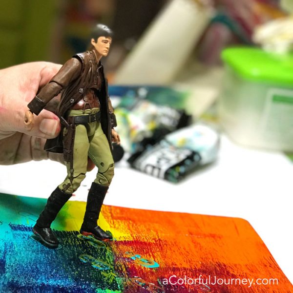 Gel printing with a toy action figure and Golden Open paints on a Gel Press Plate video tutorial by Carolyn Dube