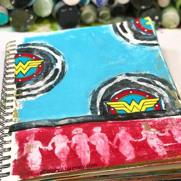 Playing in an art journal with Wonder Woman scraps and stencils and baby wipes by Carolyn Dube