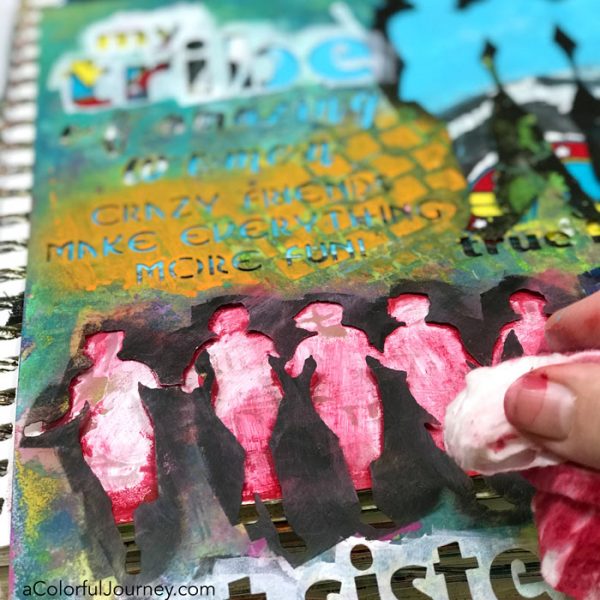 Playing in an art journal with Wonder Woman scraps and stencils and baby wipes by Carolyn Dube