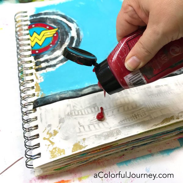 Playing in an art journal with Wonder Woman scraps and stencils and baby wipes by Carolyn Dube